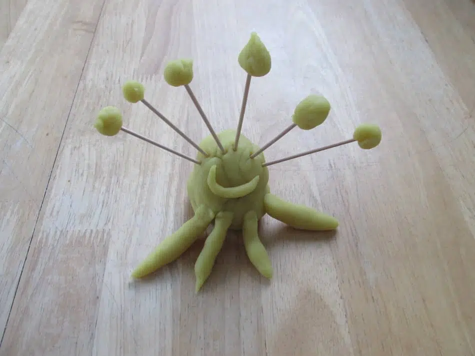 A model of an alien using playdough and cocktail sticks