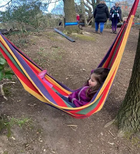 Girl swinging in a hammock