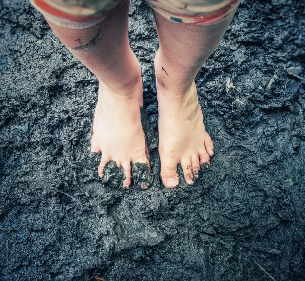 Forest bathing with feet in mud