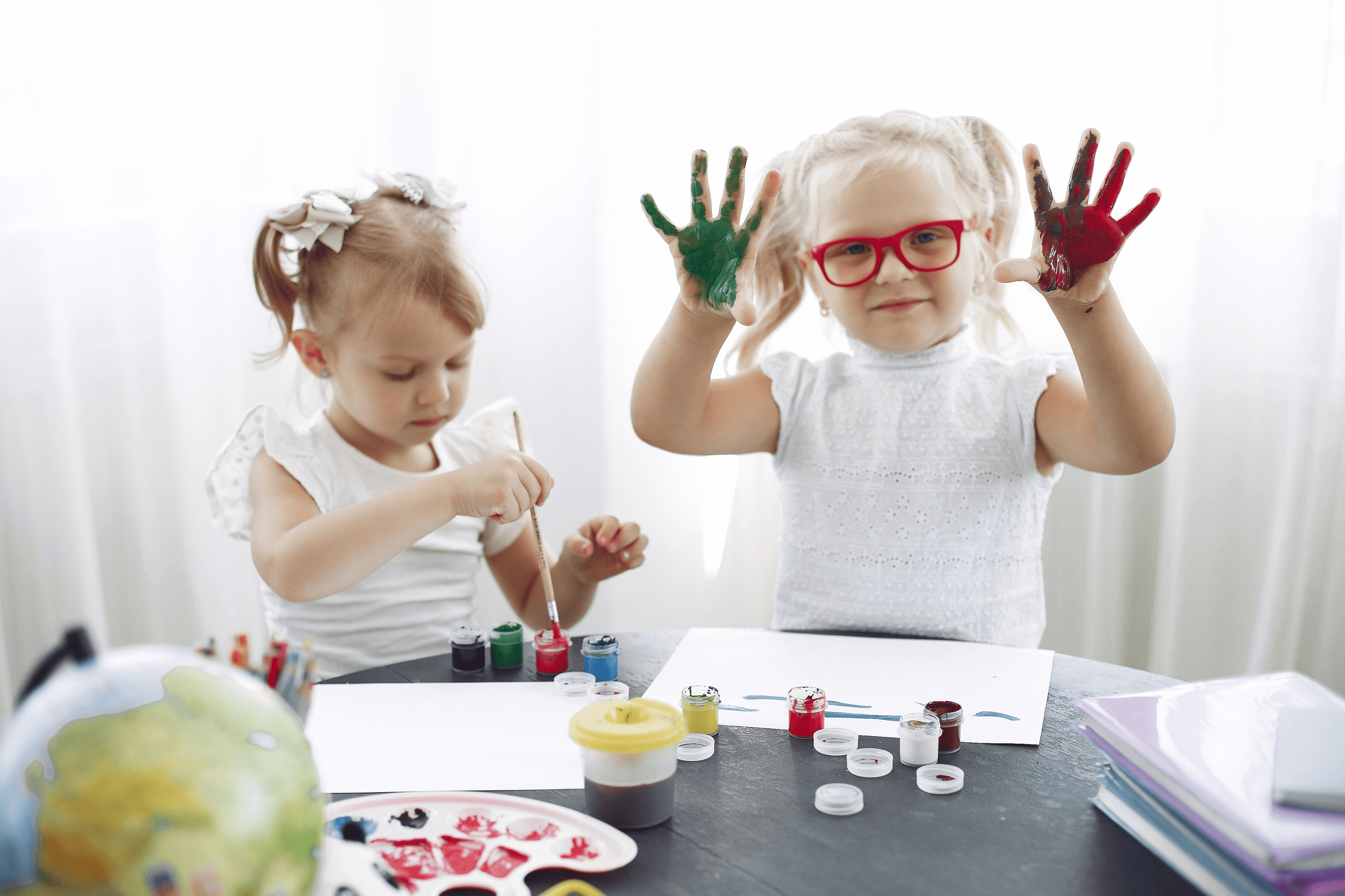 Preschoolers with hands painted with paint
