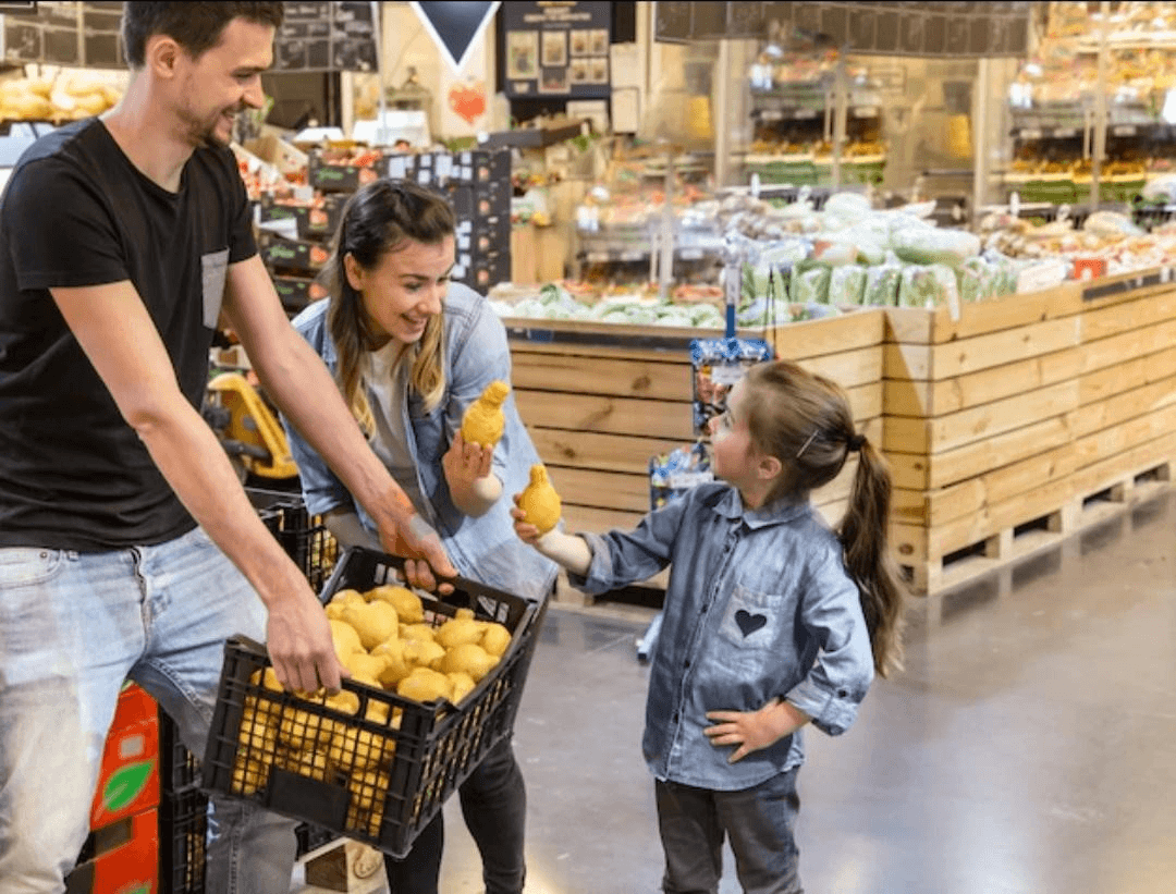 mom, dad and young daughter grocery shopping