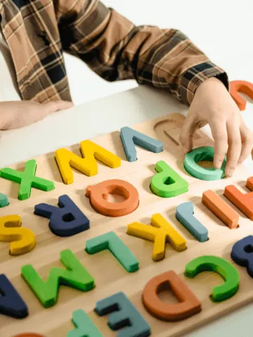 a child playing with an alphabet toy