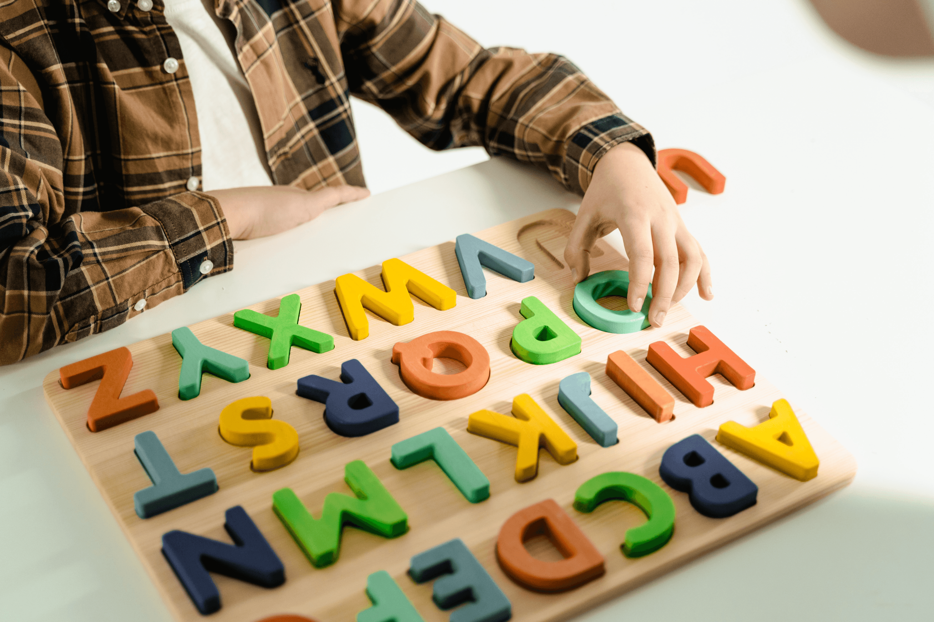  a child playing with an alphabet toy