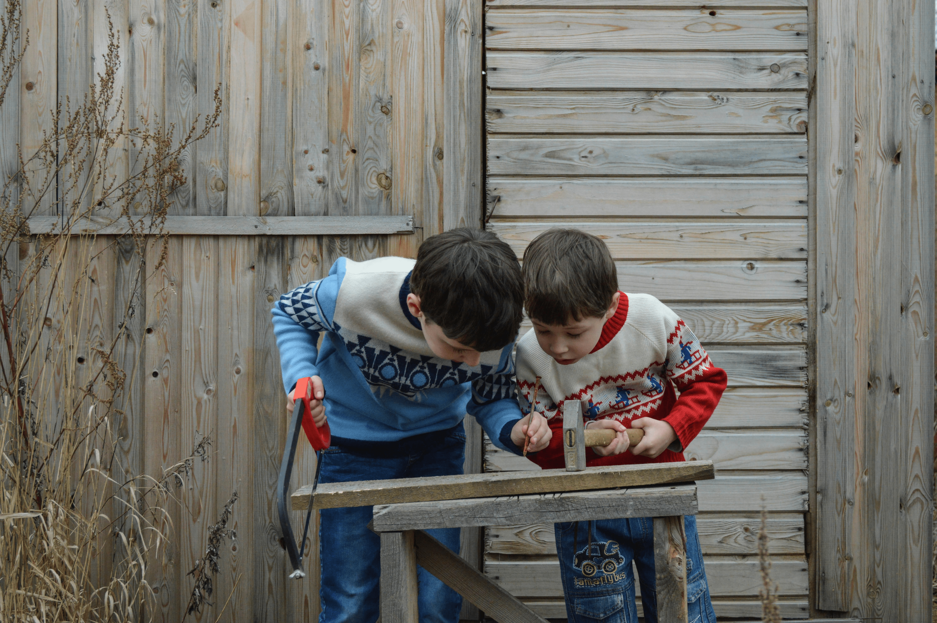 two young boys playing carpenter