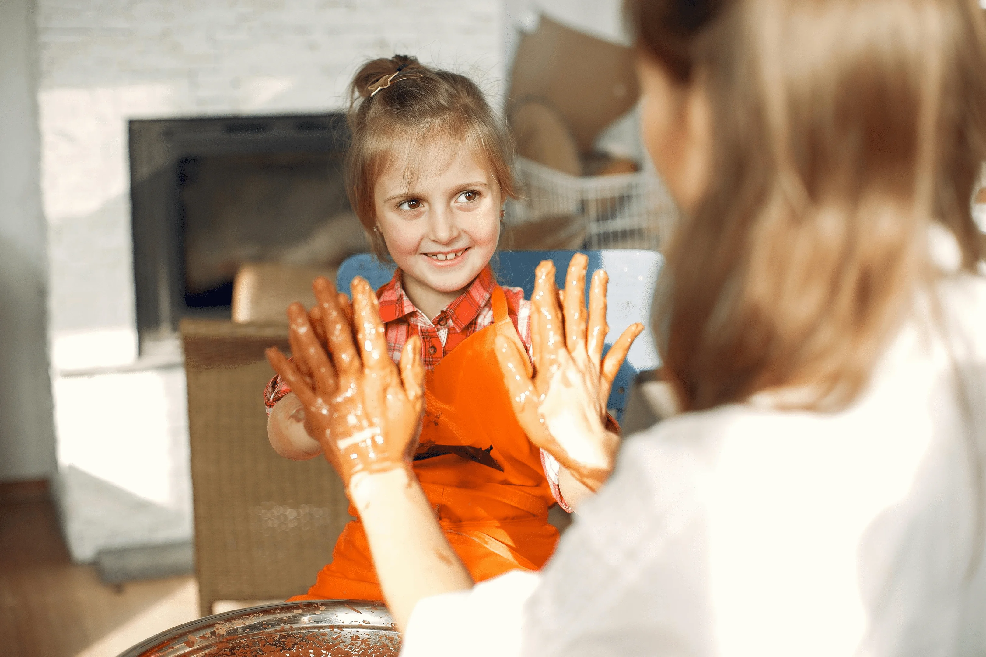 young girl and mom playing with clay